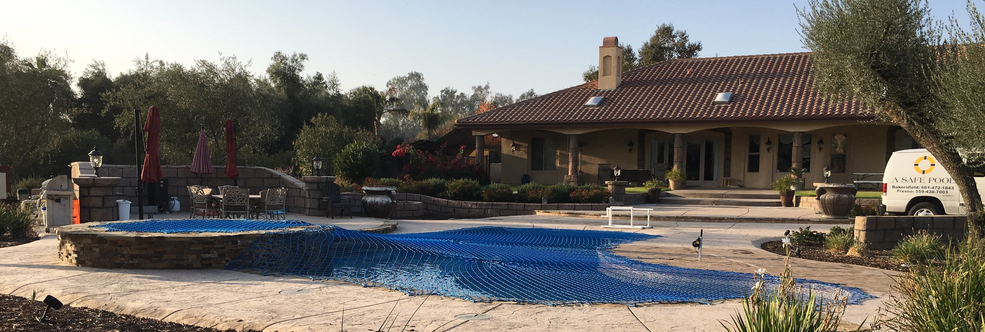 Swimming pool with a house and pool barrier